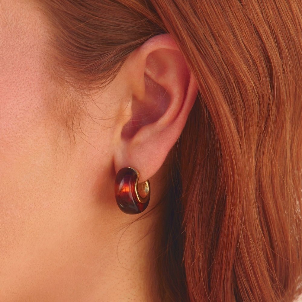 Amber Gold Hoop Earrings, worn on an ear with red hair, close-up, brown tortoiseshell with gold rim