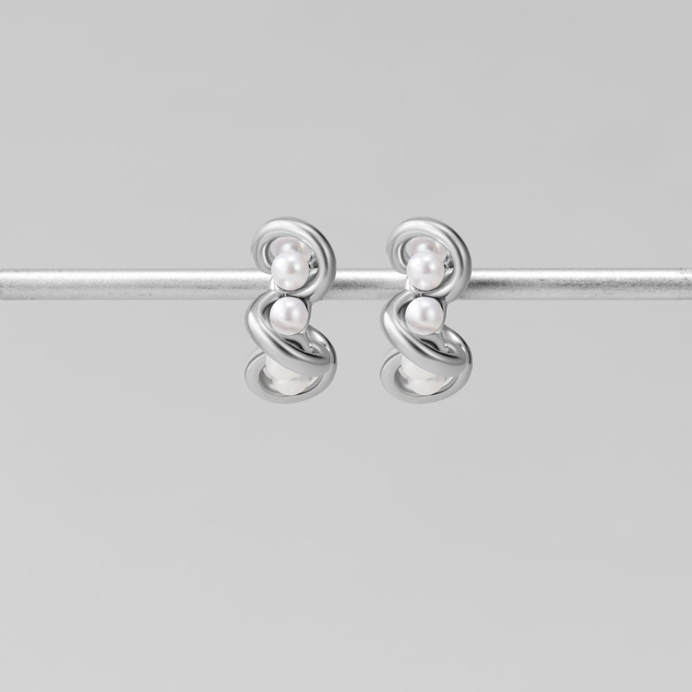 Tara Silver Entwined Pearl Earrings, pair of silver earrings with two small pearls each, hanging on a silver bar